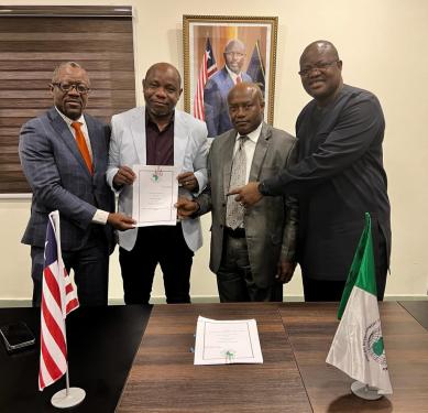 Left to Right: Executive Governor Tarlue, MFDP Minister Tweah, AfDB County Manager Kanu holp up the signed agreement while Deputy Finance Minister Augustus Flomo points to it