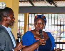 Cllr. Zeon, head of CBL Communications Section, shares information with a Market Superintendent 
